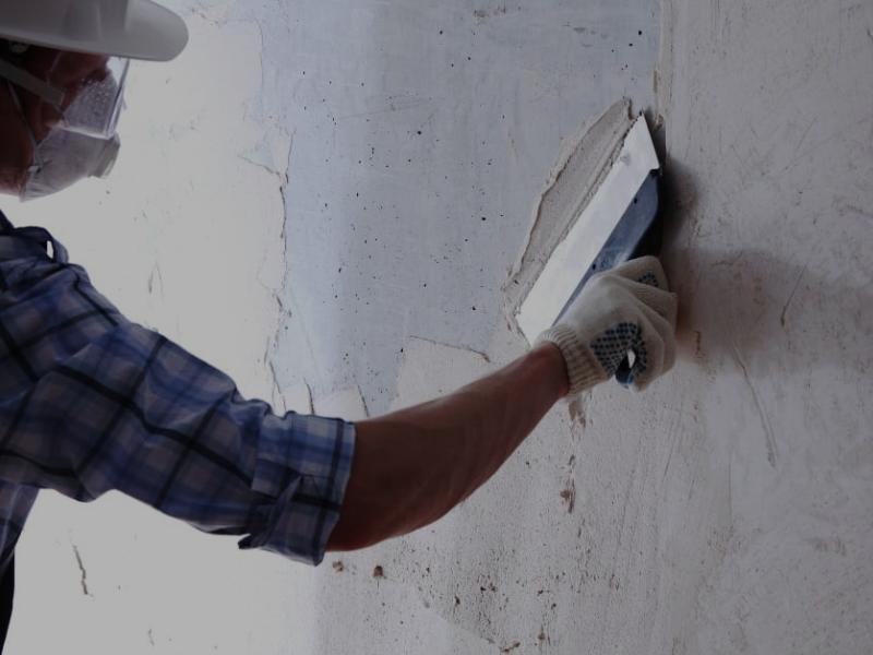 We Can Fix It All handyman performing Drywall Repair, carefully patching and sanding damaged interior wall sections.